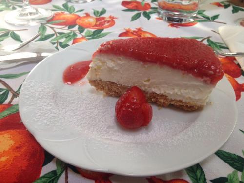 a piece of cake with a strawberry on a plate at B&B SCACCIA PENSIERI in Tarcento