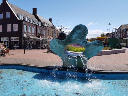 a water fountain in the middle of a street at De Eenhoorn in Oostburg