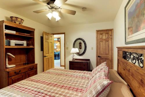 a bedroom with a bed and a ceiling fan at Snowfire 314A in Angel Fire