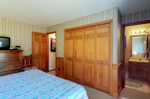 a bedroom with a bed and a dresser and a television at Snowfire 208B in Angel Fire