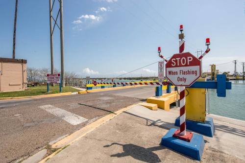 a stop sign on the side of a road at Sand Dollar Dreams in South Padre Island