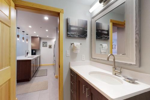 a bathroom with a sink and a mirror at Passage Point 422 in Copper Mountain