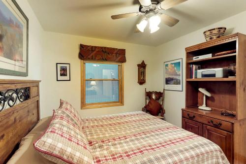 a bedroom with a bed and a ceiling fan at Snowfire 314A in Angel Fire