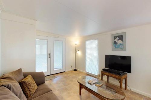 a living room with a couch and a flat screen tv at Sand Dollar Dreams in South Padre Island