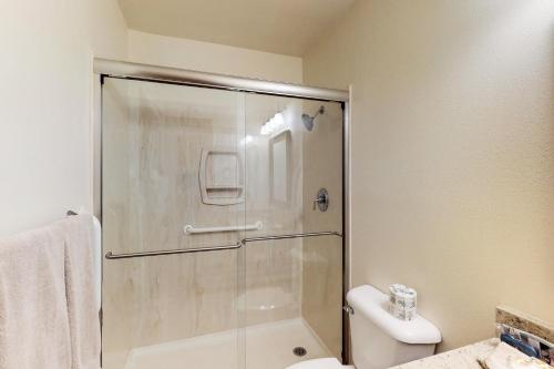 a bathroom with a shower and a toilet and a sink at Snowfire 314A in Angel Fire