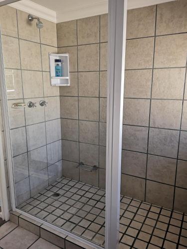 a bathroom with a shower with a glass door at On Cloud 9 in Hermanus