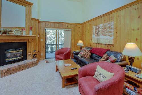 a living room with a couch and a fireplace at Snowfire 307A in Angel Fire