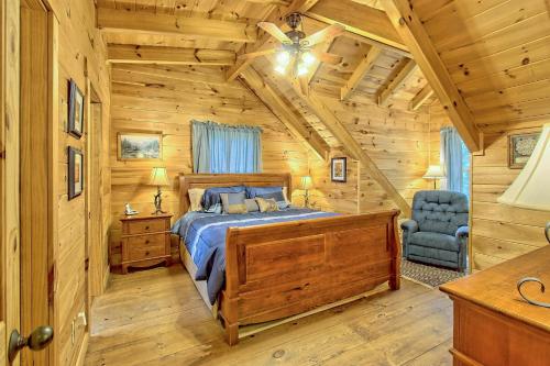 a bedroom with a bed in a log cabin at Sunset Valley in Ellijay