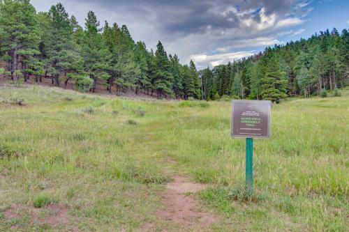 a sign in the middle of a field with trees at Snowfire 307A in Angel Fire