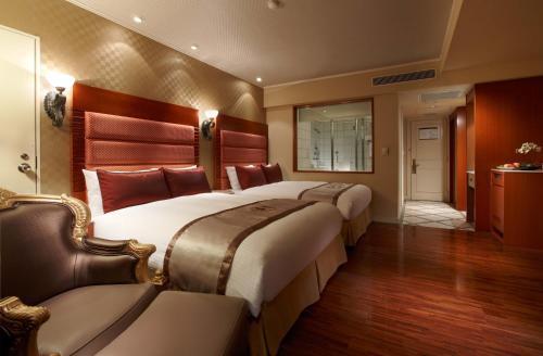 Ένα ή περισσότερα κρεβάτια σε δωμάτιο στο Hualien Charming City Hotel