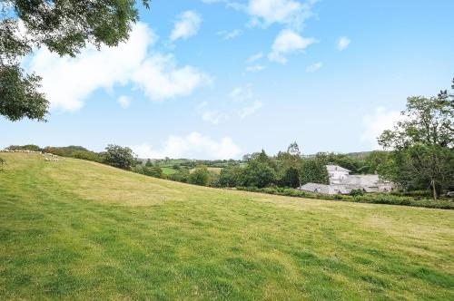 a grassy hill with a house in the background at Corffe House and Holiday Cottages in Barnstaple