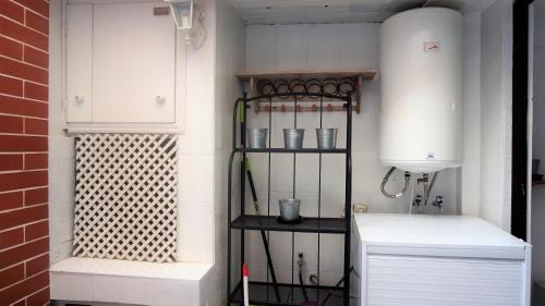 a corner of a room with a shelf and white cabinets at Casa Borguny - House in the centre of Palma in Palma de Mallorca