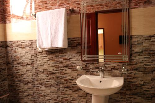 a bathroom with a sink and a mirror at Agenda 2000 Hotels Ltd in Kampala