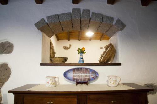 a room with a table with a mirror on a wall at Turismo Rurale Belvedere Pradonos in Dorgali