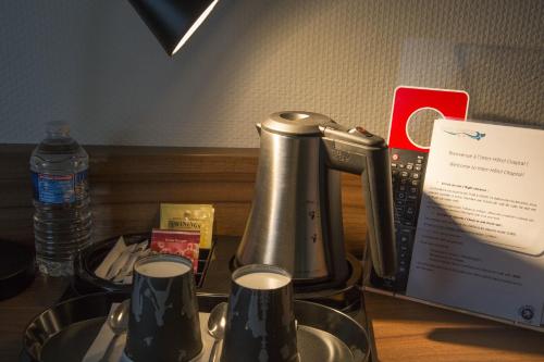 a coffeemaker sitting on a counter next to at Logis Hôtel Chaptal, Amboise in Amboise