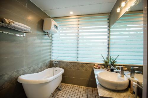 a bathroom with a white toilet and a sink at Dalat Terrasse Des Roses Villa in Da Lat