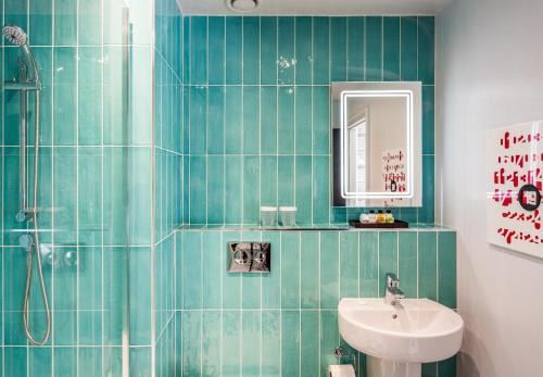a bathroom with a sink and a toilet and a mirror at ABode Manchester in Manchester
