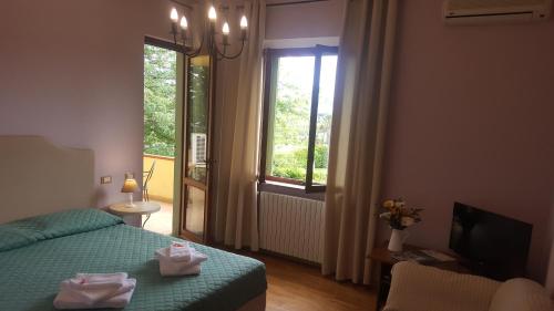 a bedroom with a green bed and a window at Casale Dell'Orso in Pistoia