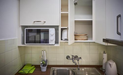 a kitchen with a sink and a microwave at Appartement Active in Saalbach Hinterglemm