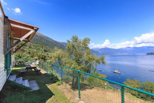 a balcony of a house with a view of a lake at Lakeview Cannobio Camping & Resort in Cannobio