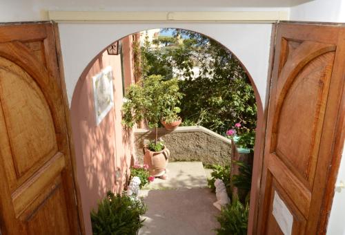 an arched doorway with potted plants in a building at Villa Maria Antonietta in Positano