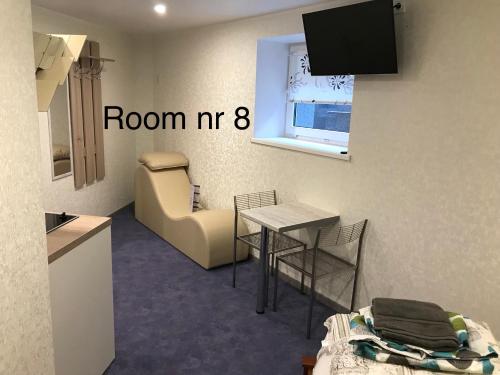 a small room with a table and a chair at Liivalaia 40 cozy kitchen studio in Tallinn