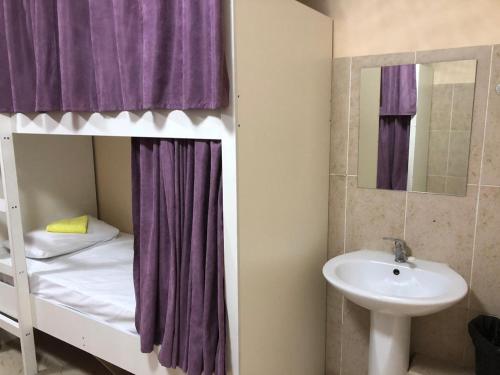 a bathroom with a bunk bed and a sink at Elite Hostel in Astana