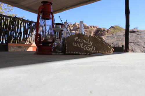a table with a bottle and a pillow on it at Madisa Camp in Kalkbron