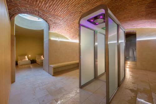 a hallway with two mirrors and a brick wall at Residenza Porta Volta in Milan