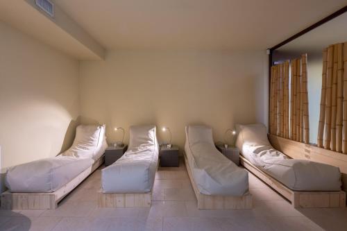 a hospital room with two beds and a mirror at Residenza Porta Volta in Milan