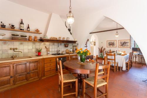 a kitchen with a table and a dining room at Podere Le Capannucce in Pontedera