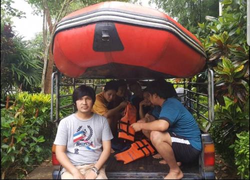 a group of people sitting on the back of a truck at Kaengkrachan River Hut in Kaeng Krachan