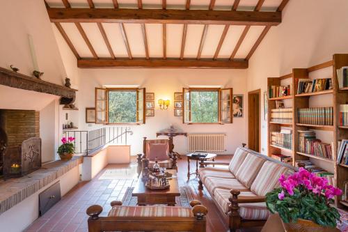 a living room with a couch and a fireplace at Podere Le Capannucce in Pontedera