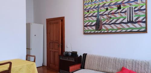 a living room with a couch and a picture on the wall at Sweet Kato Apartment in Katowice