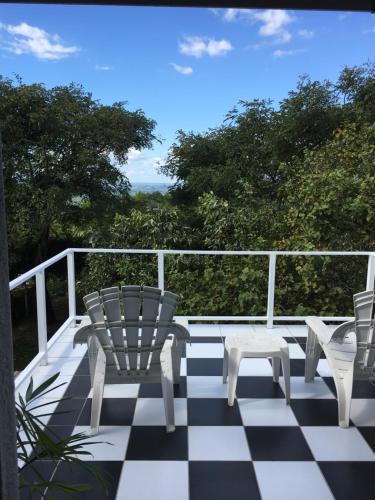 a porch with chairs and a checkered floor at Ashbourne Country Escape Hazyview in Hazyview