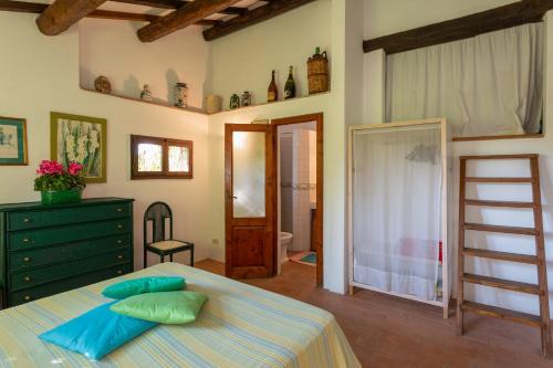 a bedroom with a bed with pillows on it at Podere Le Capannucce in Pontedera