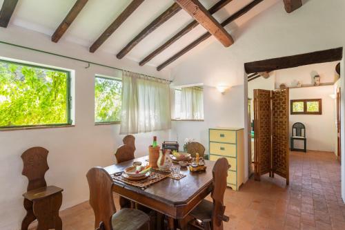 a dining room with a wooden table and chairs at Podere Le Capannucce in Pontedera
