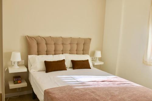 a bedroom with a large bed with two pillows at VIELHA VII in Vielha