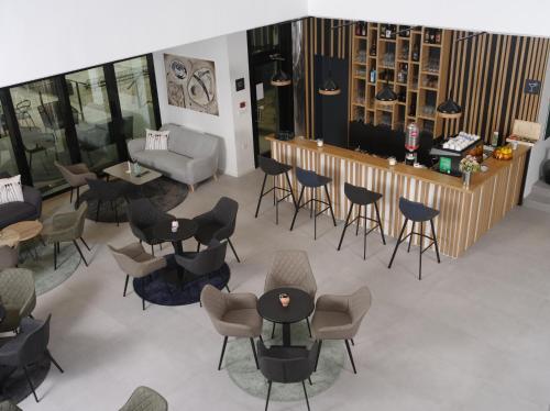 an overhead view of a waiting room with chairs and tables at Hotel Cubis in Lendava