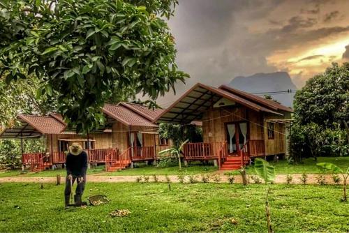 a man standing in front of a house at Chiang Dao Reset in Chiang Dao