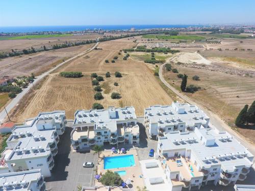an aerial view of white houses and a field at Oceania Bay Village in Pyla