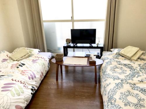 Un ou plusieurs lits dans un hébergement de l'établissement 京都パティオフィッツ Patiofits 403 #TT2