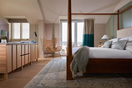 a bedroom with a bed and a kitchen with a window at Inchydoney Island Lodge & Spa in Clonakilty