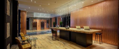 a lobby with a bar with two laptops on it at Hotel Warszawa in Warsaw