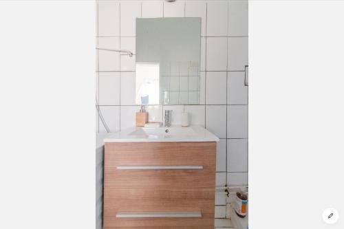 a bathroom with a sink and a mirror at Agréable cocon à la Marina de la pointe du bout in Les Trois-Îlets