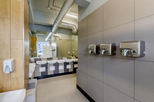 a bathroom with a row of sinks and toilets at Kapsuła Hostel Warszawa in Warsaw