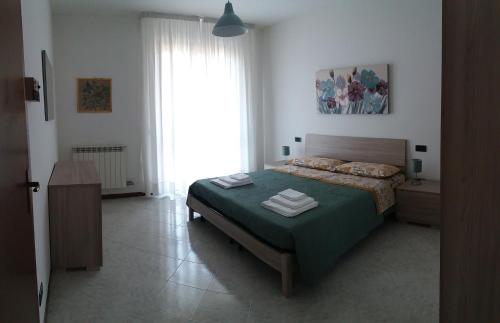 a bedroom with a bed and a large window at Villa Susy in Desenzano del Garda