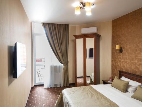 a hotel room with a bed and a window at ArcadiaSky in Odesa