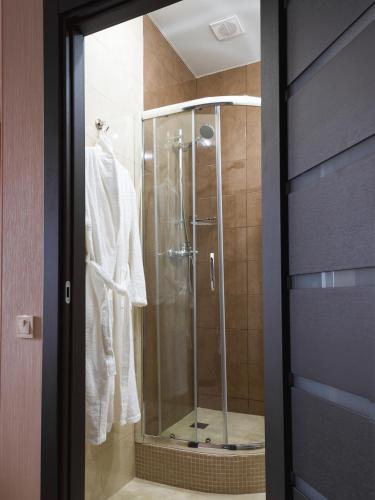 a shower in a bathroom with a glass door at ArcadiaSky in Odesa