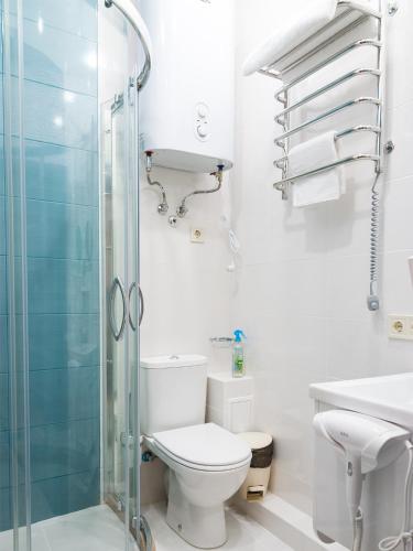 a bathroom with a toilet and a glass shower at ArcadiaSky in Odesa